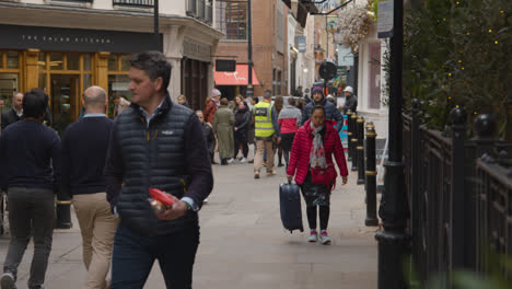 Pull-Focus-Shot-Of-Shops-And-Restaurants-With-People-On-Avery-Row-In-Mayfair-London-UK-1